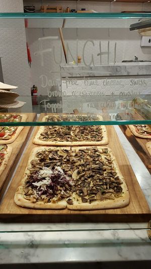 Funghi pizza with Dairy-free  blue cheese, swiss brown mashrooms + parsley. Topped with radicchio, walnuts + dairy-free parmesan. at By GiGi in Miami