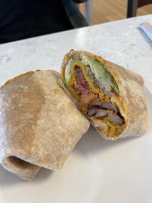 The common roots breakfast burrito, with added cheese saucee  at Common Roots Cafe in Rye