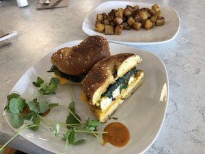 Tofu “egg” breakfast sandwich and home fries   at Common Roots Cafe in Rye