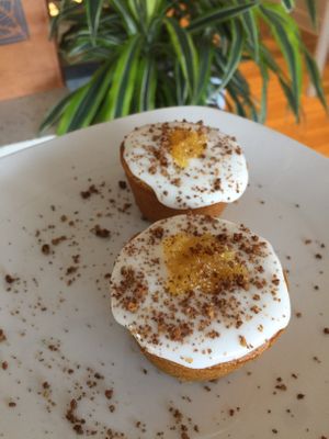 Vanilla cupcakes, pineapple ginger jam, royal icing, cocoa graham cracker crumbles. #plantbased #vegancupcakes at Common Roots Cafe in Rye