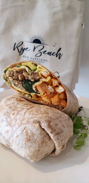 Cali Dip breakfast burrito, cashew nacho cheese, veggie sausage, avocado, spinach, sprouts, vegan eggs, seasoned fries.  at Common Roots Cafe in Rye