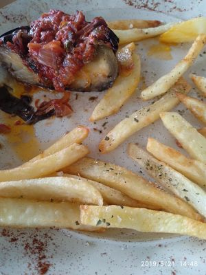 Stuffed eggplants with tomato sauce and other things accompanied by fried potatoes. Vegan! We shared between 2 and it was 7 euros. Saved our life this restaurant close to elafonisi at Kosmos in Crete