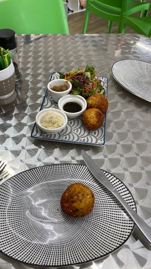 Falafel balls served with sauce and salad at Health Healing & Harmony in Innisfail