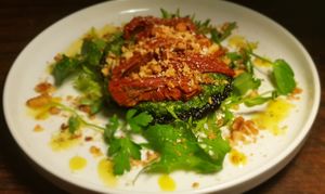 Portobello mushroom filled with salsa verde sundried tomato topped with toasted pine nuts and vegan parmesan 
On a bed of salad dressed with Sicilian lemon oil  at The Garden Cafe and Takeaway in Kendal
