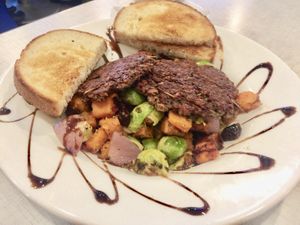 Vegan Sweet Potato & Brussels Sprout Hash
Roasted Brussels sprouts & red onion, with sweet potatoes, & dried cherries. Topped with balsamic reduction, choice of toast.  at Anna's House in Holland