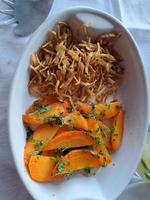 Fried onions and steamed carrots to top the rice cake at La Luna in Manuel Antonio