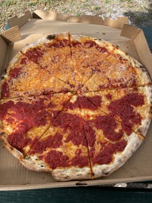 Half regular half garlic parm pizza at Mora Pizza in Miami