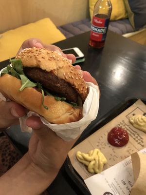 Burger innovatively wrapped in the paper at Hank Cuisine Végétale - Rochechouart in Paris