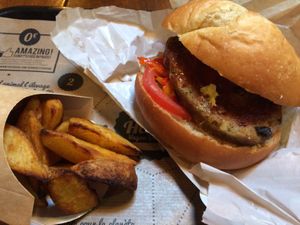 Burger with pickles, and potato wedges at Hank Cuisine Végétale - Rochechouart in Paris