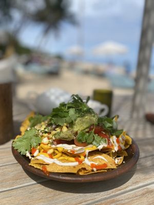 Vegan nacho bowl with vegan cheese and vegan sour cream, beans and guacamole 🥑   at Genius Cafe in Sanur