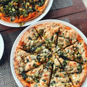 Cashew cheese pizza, loads of green veggies and a nice thick crispy base to hold it together at Pumpernickel Bakery and Babylon Cafe in Pokhara