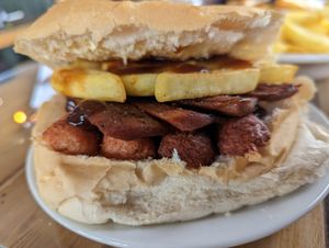 Vegan bacon and sausage sandwich with chips at The Avenues Cafe in Nottingham