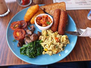 "Planted Swamp" vegan breakfast. Has veggie sausages, hash browns, grilled tomatoes, mushrooms, beans, toast, wilted peppered spinach and a tofu scramble with peppers at Cranberry Swamp in Whitby