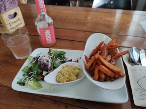 Sweet potatoes fries, hummus, salad, and soft drink at Genusswerkstatt in Potsdam