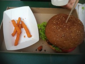 Sweet Dream burger with the remnants of the sweet potato fries that come along with it at Las Vegan's - Vegan Garden Trailer in Budapest