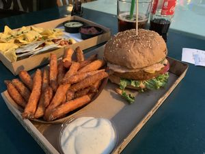 seitan burger with sweet potato fries (vexicana pictured in the background) at Las Vegan's - Vegan Garden Trailer in Budapest