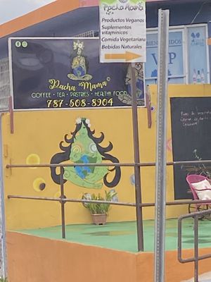 outside (yellow building, green sign) beautiful artwork too😄 at Pachamama Health Food in Humacao