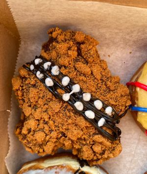 Star Wars Day release. Wookie Butter. Cookie butter creme filling, glazed with chocolate, and coated in Biscoff cookie crumbs.  at Strange Matter Coffee - Eastside in Lansing