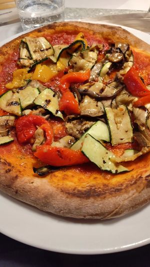 Pizza with a side of vegetables added. at Olivo in Verona