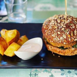 Goumet burger e patatas bravas con vegan alioli  at Veg Joy in Rome