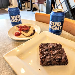 Vegan cheesecake with strawberry topping and a vegan walnut brownie. (And BUD LIGHT!) at Archibowls in Lawrence