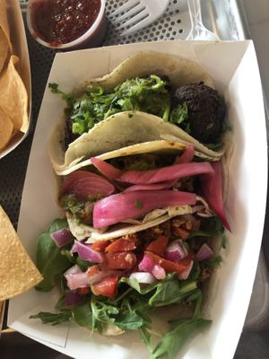 Vegan chorizo (w tomatoes and spinach), curried sweet potato, and black bean falafel craft tacos served as they come. Delicious and quaint taqueria!! at Screaming Goat in Sarasota