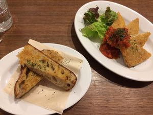 Koya tofu cutlets with tomatoe sauce and side order of garlic bread. at Cafe Bask in Tokyo
