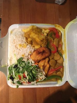 White rice, stewed beans, plantain, turned corn and salad at Hill's Carib Flava in Haledon