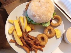 Vegan burger with fries and onion rings at Peter Pane in Vienna