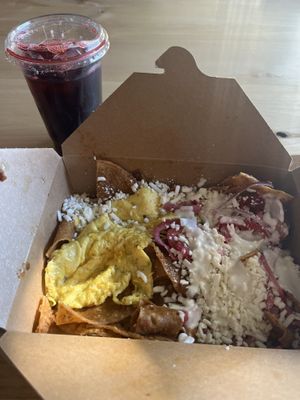 Chilaquiles with egg and Jamaica agua fresca   at Delicias Bakery in Los Angeles