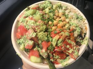 Bowl: garbanzo beans, brown rice, watermelon, kale, corn, red bell peppers, grilled onions, cauliflower, greens, cilantro and cucumber topped with their ají verde sauce! Sooo   at Fresh Griller  in Downey