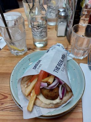 flatbread with humus, fries and zucchini fritters at The Real Greek - Old Spitalfields Market in East London