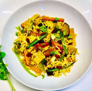 Chi’ken stir fry with spicy noodles topped with goji berries. at Lil Mama's Vegan Kitchen in Paignton