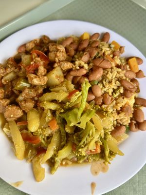 Brown rice with beans on top, soy chunks in tomato stew, mixed veggiess  at Tony's F in Santo Domingo
