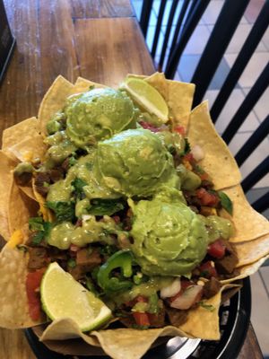 Vegan Nachos "Al Pastor" (Soy Protein) (Gluten-Free) with Corn tortilla chips, queso, guacamole. black Beans, Potatoes & Bell Peppers ❌🐷 no pigs harmed at Vegan GreenGO in Santa Barbara
