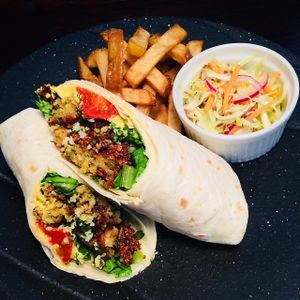 A Mediterranean favourite: warm falafel, lemon-kissed hummus, fresh tabbouleh and curried yoghurt sauce is wrapped in a fresh, flour tortilla. Served with fries and coleslaw. at D'Vine Restaurant & Lounge in Nikko