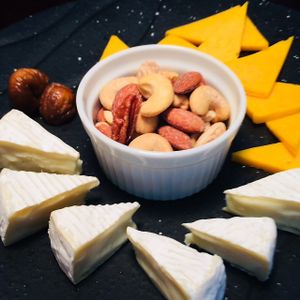Roasted & salted nuts accompanied by cheddar & camembert cheeses and a dried fig. at D'Vine Restaurant & Lounge in Nikko