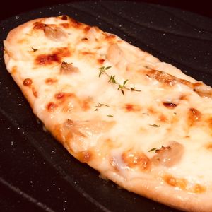 Plump, oven-roasted cloves of garlic, Canadian honey and gooey mozzarella on our hand-made crust. at D'Vine Restaurant & Lounge in Nikko