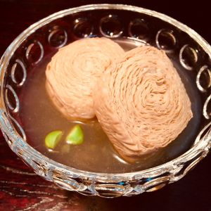 Nikko's most famous dish. Enjoy the texture of these rolled tofu sheets simmered in a Japanese broth. at D'Vine Restaurant & Lounge in Nikko