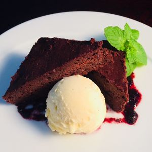 Vanilla ice cream cozies up to a rich & fudgy brownie enhanced with a hint of rum, chocolate chunks & crystalline slivers of candied Japanese ginger. at D'Vine Restaurant & Lounge in Nikko