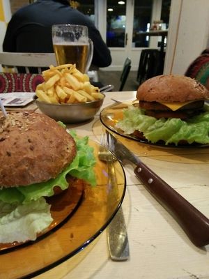 Homemade burger bun, veggie burger, vegan cheese, caramelized onions, salad and tomato. Large portion of fries at Melemele Burguer in Zarautz