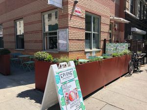 Sun and shade outdoor seating  at Ambrosia Elixirs in Brooklyn