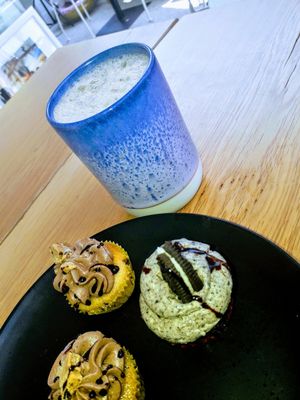 Vegan chai latte and three vegan cupcakes... two with cookie dough flavour, and one with Oreo flavour. at Bake My Day in Copenhagen