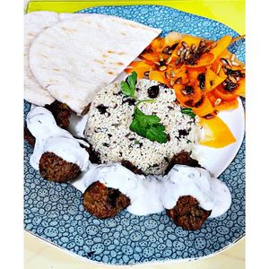 Karmic lamb style kofta with lemon mint dressing, mint & pomegranate couscous , Harissa carrot and toasted sunflower seed salad and pitta. 🌱 at Karmic Cakery in Berwick-upon-tweed