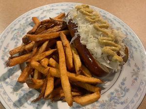 Beyond brat on pretzel bun with sauerkraut and French fries   at Thrive Diner in Pittsfield