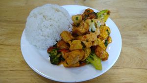 Fried tofu with vegetable, mushrooms, tomato sauce and rice. at V-Cuisine in Hanoi