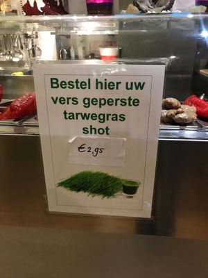“Order here your freshly pressed wheatgrass shot" at Unlimited Health in Amsterdam