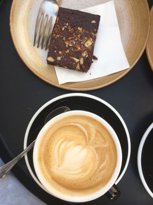Latte with oat milk and a vegan brownie at Deep Coffee Roaster in Marseille