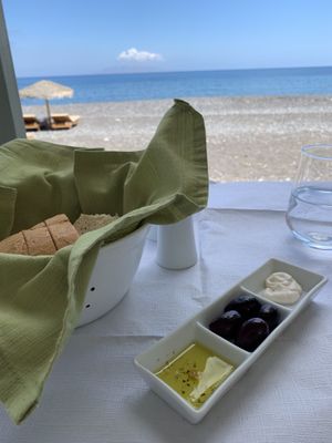 Bread with olive oil and a white dip we’re not sure if it was vegan or not. at Vassilikos in Santorini