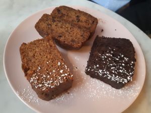 Vegan cakes: banana bread, carrot cake and chocolate cake at Plantate Cafe in Madrid